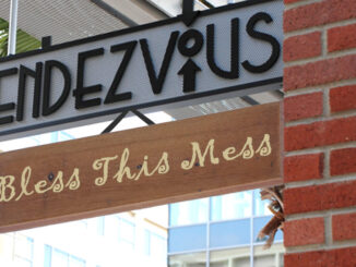 Rendezvous sign with additional sign that says "Bless this mess"