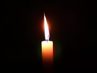 candle burning in darkness